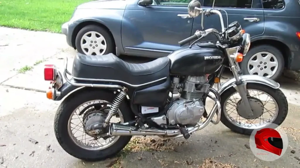 Black Honda CM400 with wire-spoke wheels and drum brakes, side view showing its standard riding position