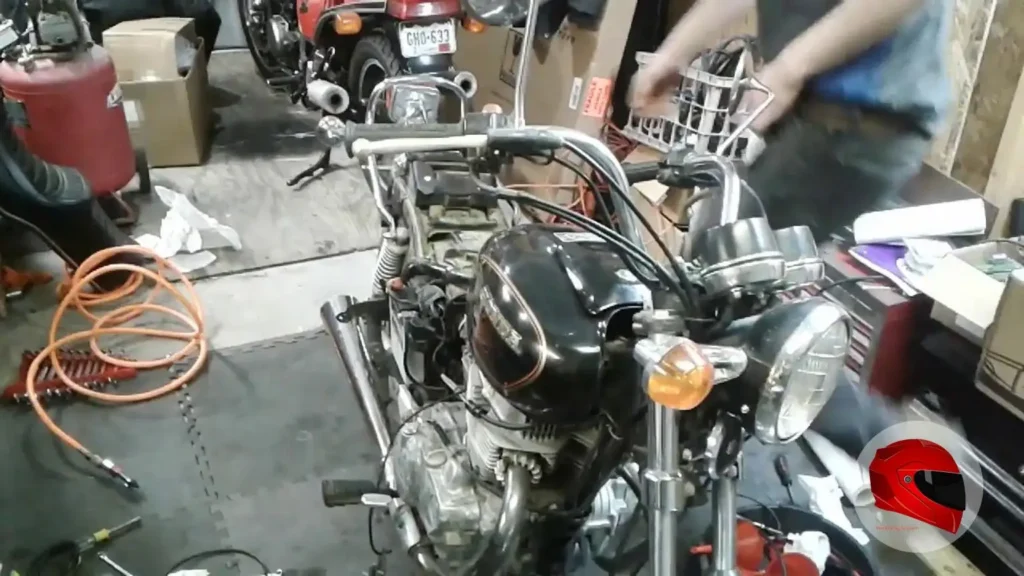 Close view of a 1981 Honda CM400E engine and front end in a workshop