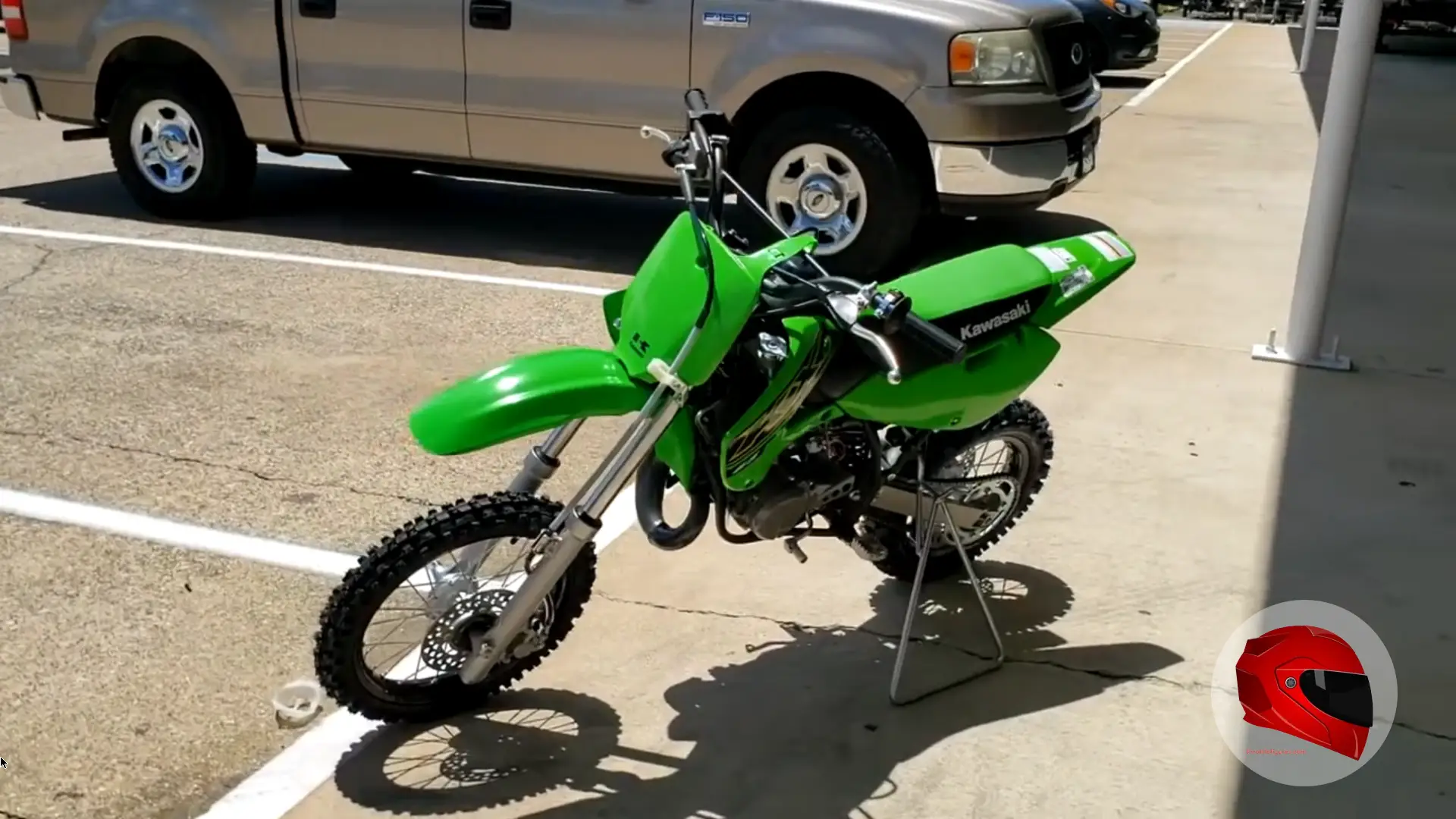 Green Kawasaki dirt bike parked outdoors