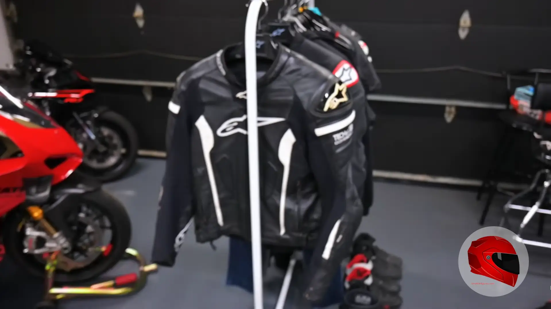 Motorcycle riding gear: leather jackets on a rack with sportbike