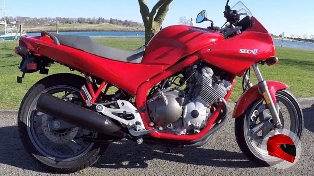 Side view of a red Yamaha XJ600 Seca II, showing the half-fairing, fuel tank, seat and exhaust