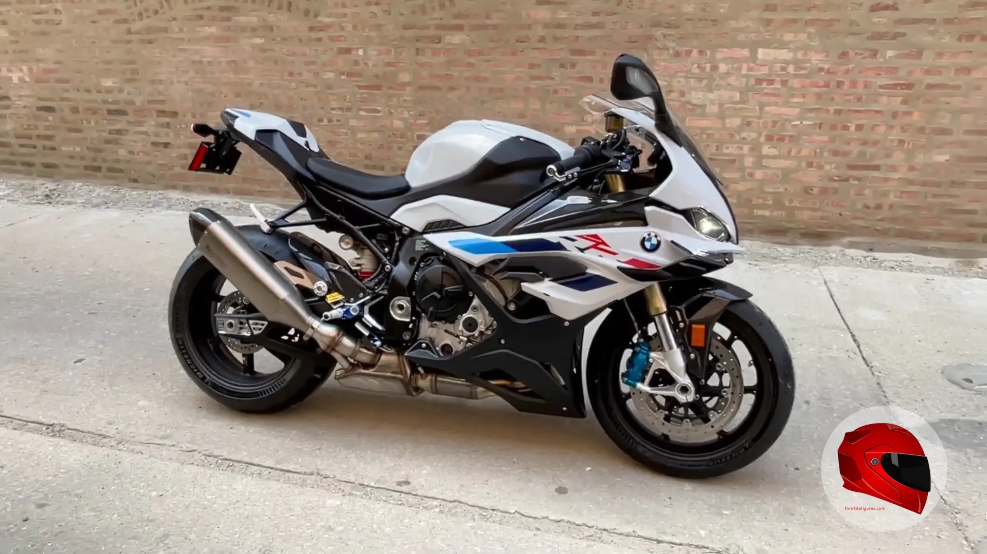 White BMW S 1000 RR parked by a brick wall